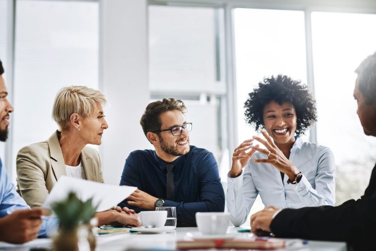 Shot of a group of businesspeople sitting together in a meeting